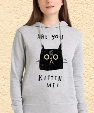 Woman wearing a grey hoodie with an Are you kitten me? cat design